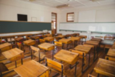 Empty chairs and tables in classroom at university