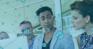 Presenting data on laptop in office by team with male wearing gray blazer, showing network icons. Collaboration, technology, teamwork, innovation, digital, modern, professional