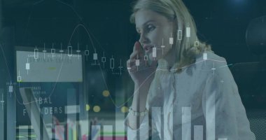 Talking businesswoman in blouse using smartphone and laptop in office at night, monitoring charts. Professional, workspace, modern, finance, urban, corporate, technology