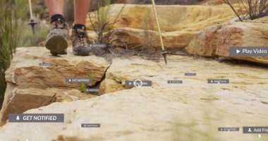 Yürüyüşçü, UI simgelerini kullanarak çıkıntıya çıkıyor ve teknolojik aktiviteleri gösteriyor. Macera, keşif, engebeli, açık hava, teknoloji, etkileşimli, navigasyon