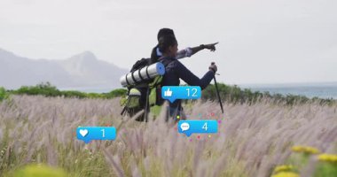 Yürüyüş yapan çift ufku gösteren direği kaldırıyor, çayırda yürüyor ve pazarlama için yüzen ikonları izliyor. Macera, keşif, açık hava, yolculuk, boş zaman, yaban hayat, bağlantı