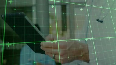 Doctor initiating data analysis on tablet in clinic as green grid overlay appearing across screen. Medical, technology, interface, healthcare, analysis, translucence, digital