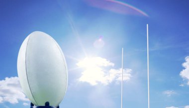 Rugby ball in front of posts