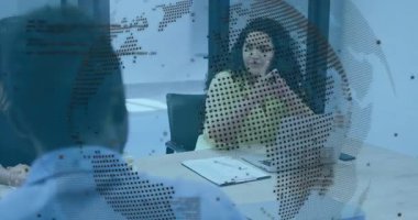 Sarı bluzlu kadın konuşurken dizüstü bilgisayara haritalı iş toplantısını işaret ediyor. İşbirliği, takım çalışması, iletişim, profesyonel, modern, strateji, tartışma