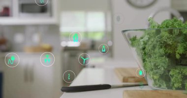 Ev aşçısı tezgahın üstüne demlik koyuyor, yeşil ikonların lahana kasesinin etrafında kıvrılıp durduğunu gösteriyor. Sürdürülebilirlik, sağlıklı beslenme, enerji tasarrufu, çevre dostu, aşçılık, modern mutfak, yaşam tarzı