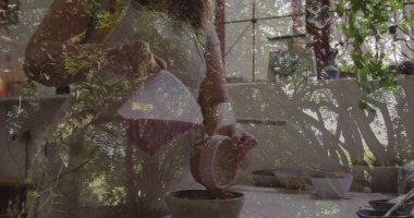 Önlük giymiş bir kadın pencerenin yanındaki mutfak tezgahında seramik sürahide kahve dolduruyordu. Ev, mutfak, yaşam tarzı, minimalizm, dinginlik, doğal, parlak