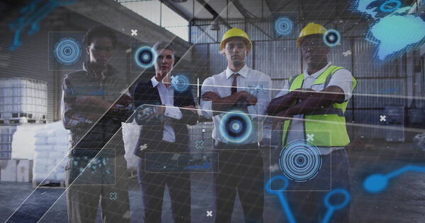 Collaborating team wearing yellow hard hats and vest studying holograms around pallets in warehouse. Industrial, teamwork, safety, logistics, technology, productivity, corporate