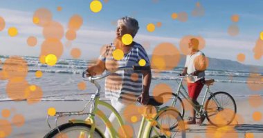 Turuncu daireler plajda beliriyor. Sağlık sahnesinde kadın ve erkeklerin bisiklet sürdüğünü gösteriyor. Plajlar, eğlence, rahatlama, sükunet, macera, açık hava, refah