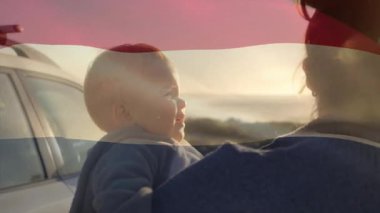 Annem beyaz SUV 'un yanına geliyor. Elinde bebek rehberiyle okyanusa bakıyor. Sağlıklı güneş ışınlarıyla. Deniz kenarı, siluet, bağ, sükunet, keşif, doğa, aile