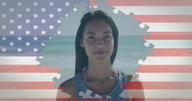 Sahilde, pazarlamada bayrağın üzerinde beliren yapboz maskesini izleyen bir kadın gülümsediğini gösteriyor. Vatanseverlik, dinginlik, iyimserlik, kutlama, tatil, boş zaman, rakam