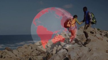 Teknoloji temalı dönen küre açılışı yapan çift kayalık uçuruma tırmanıyor, yardım için elini uzatan adam. Macera, keşif, takım çalışması, açık hava, engebeli, manzaralı, canlılık