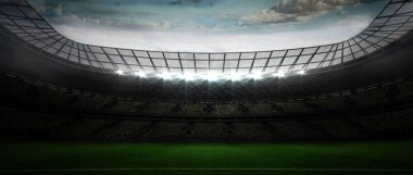 Boş çim sahası kıvrımlı çatı kirişlerinin altında duruyor, projektörler katmanlı tribünlerin üzerinde parlıyor. Stadyum, eğlence, spor, arena, mimari, açık hava, aydınlatma