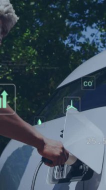 Animation of data processing and ecology icons over senior african american man fueling car. Global ecology, car and digital interface concept digitally generated video.