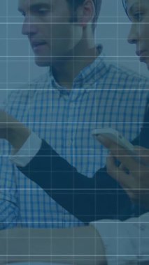 Animation of graphs and numbers on grid pattern over diverse coworkers discussing report on laptop. Digital composite, multiple exposure, business, digits, teamwork, communication and technology.