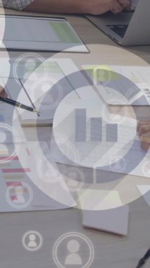 Animation of financial data processing over diverse business people working in office. Global business, finances, computing and data processing concept digitally generated video.