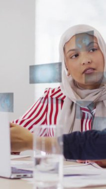 Animation of financial data processing over diverse business people in office. Global business, finances, computing and data processing concept digitally generated video.