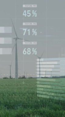 Çayırlarda gri gökyüzüne karşı dönen yel değirmenlerinin istatistiksel veri işleme sistemi. İş verileri ve yenilenebilir enerji teknolojisi kavramı