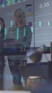 Animation of financial data processing over diverse business people. Global business, finances, computing and data processing concept digitally generated video.