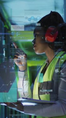 Sunucu odasında kulaklık kullanan Afrikalı Amerikalı bir kadının veri işleme animasyonu. Bulut hesaplama, dijital arayüz ve güvenlik konsepti dijital olarak oluşturulmuş video.