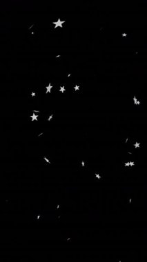 Siyah arka planda düşen noel yıldızlarının animasyonu. Noel, gelenek ve kutlama konsepti dijital olarak oluşturuldu.