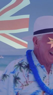 Avustralya bayrağı ve yıldız animasyonu tropikal gömlekli yaşlı bir adamın kumsalda eğlenmesi üzerine. Son sınıf, tatil, rahatlama, cennet, eğlence, sahil şeridi.