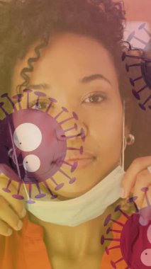 Yüz maskesi takan Afrikalı Amerikalı bir kadının portresine karşı hareket eden çoklu covid-19 hücreleri. Coronavirus covid-19 salgın konsepti