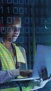 Animation of binary coding over african american male it engineer and computer servers. Global computing and data processing concept digitally generated video.