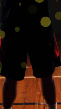 Kafkas basketbolcunun top attığı ve siyah arka planda ışık lekeleri oluşturduğu animasyon. Spor, rekabet ve hareket kavramı dijital olarak oluşturulmuş imaj.