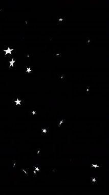 Siyah arka planda düşen noel yıldızlarının animasyonu. Noel, gelenek ve kutlama konsepti dijital olarak oluşturuldu.