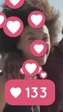 Animation of numbers and love digital icons over smiling friends on beach. digital interface, social media and global networking concept digitally generated video.