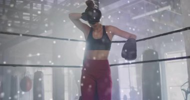 Dişi boksör halata yaslanıyor parçacıkların ışık yaylarını oluşturmasını izliyor, bir sonraki müsabaka için gardını alıyor. Sporcu, zindelik, dinamik, enerjik, çağdaş, güç, kararlılık