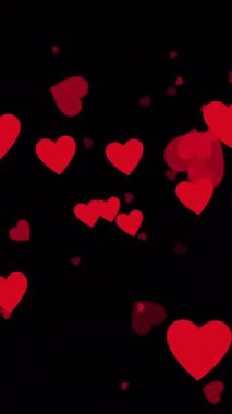 Siyah arka planda yüzen kırmızı kalplerin animasyonu. Aşk, romantizm, sevgililer günü, renk, şekil, ışık ve hareket konsepti dijital olarak oluşturulmuş video.
