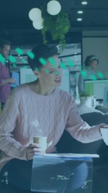 Animation of data processing over diverse business people working in office. Global business, finances, computing and data processing concept digitally generated video.