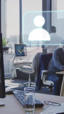 Animation of icons and data processing over diverse business people in office. Global business, finances, computing and data processing concept digitally generated video.