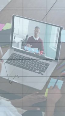 Animation of financial graphs and data over african american female designer having video call. economy, finance and business concept digitally generated video.