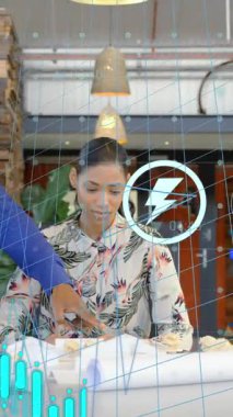 Animation of financial data processing over diverse business people working in office. Global business, finances, computing and data processing concept digitally generated video.