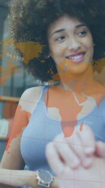 Animation of financial data processing and world map over diverse business people in office. Global business, finance, computing and data processing concept digitally generated video.