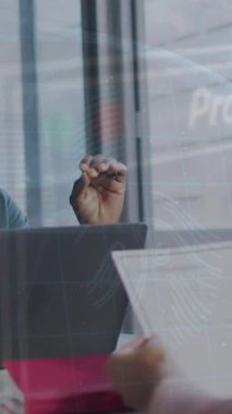 Animation of data processing over diverse business people in office. Global business, finances, computing and data processing concept digitally generated video.