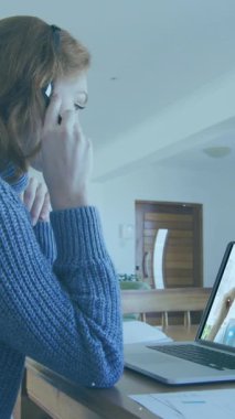 Animation of thunder over caucasian woman having a video call on laptop at home. Global networking and business technology concept