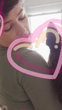 Animation of hearts over caucasian woman with her pet dog. Valentines, love and celebration concept digitally generated video.