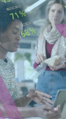Animation of financial data processing over diverse businesswomen in office. Global business, finance, computing and data processing concept digitally generated video.
