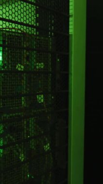 Animation of binary coding data processing and symbols against computer server room. Computer interface and business data storage technology concept