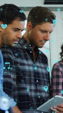 Animation of network of digital icons over diverse office colleagues discussing together at office. Global networking and business technology concept