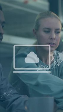 Animation of data processing over diverse man and woman discussing over laptop at office. Computer interface and business technology concept