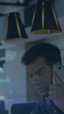 Animation of caucasian businessman using tablet over with smartphone. Global business finances during covid pandemic concept digitally generated video.