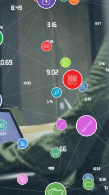 Animation of network of digital icons over diverse man and woman discussing at office. Global networking and business technology concept