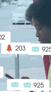 Akıllı telefon kullanan Afro-Amerikan kadın üzerinde ikon ve veri işleme animasyonları. Dijital olarak oluşturulmuş küresel sosyal medya, bağlantılar, hesaplama ve veri işleme kavramı.