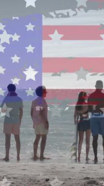 Amerika bayrağı ve yıldızların sahildeki farklı arkadaşlar üzerindeki animasyonu. Vatanseverlik ve kutlama konsepti dijital olarak oluşturulmuş video.