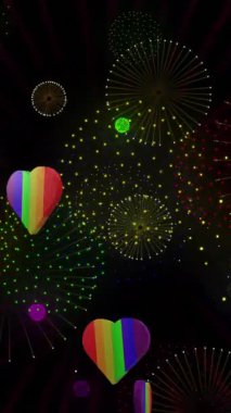 Gururlu gökkuşağı kalplerinin ve siyah arka planda patlayan havai fişeklerin animasyonu. Gurur ayı, lgbt, insan hakları ve eşitlik kavramı dijital olarak oluşturulmuş video.