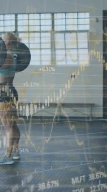 Animation of financial data processing over woman and man in face masks exercising in gym. Global covid 19 pandemic, fitness, computing and data processing concept digitally generated video.